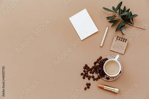Blank paper card and a cup of coffee. Minimalist concept. Business template, copy space, flat lay. Modern desk workspace
