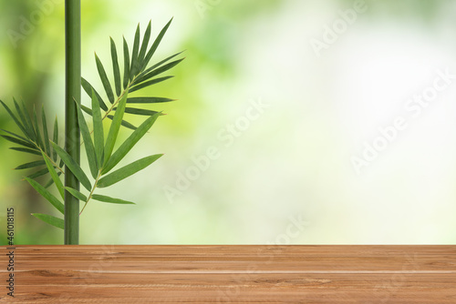 Empty table wood and bamboo leave on bokeh nature background.