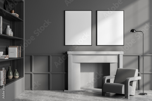 Grey living room interior with armchair  bookshelf and mock up posters