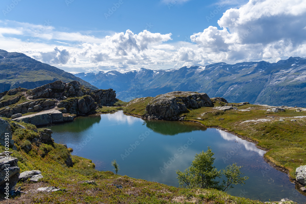 Hiking the famous Dronningstien (the Queen’s route). Stunning view of the Sørfjord, Hardangerfjord and Folgefonna glacier from the Hardangervidda plateau, Hardanger, Norway.