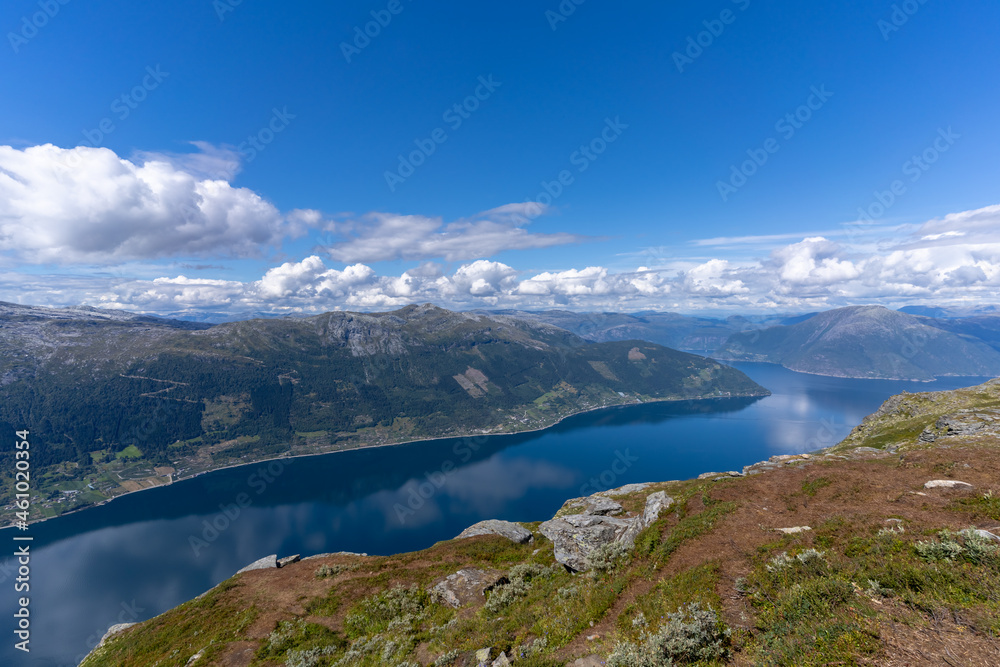 Hiking the famous Dronningstien (the Queen’s route). Stunning view of the Sørfjord, Hardangerfjord and Folgefonna glacier from the Hardangervidda plateau, Hardanger, Norway.
