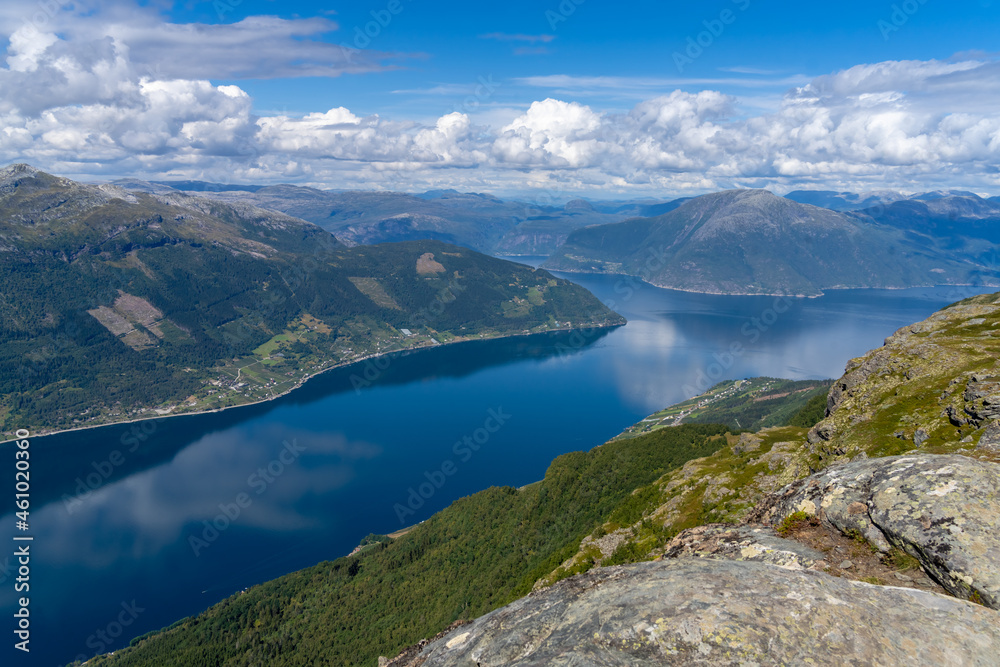 Hiking the famous Dronningstien (the Queen’s route). Stunning view of the Sørfjord, Hardangerfjord and Folgefonna glacier from the Hardangervidda plateau, Hardanger, Norway.
