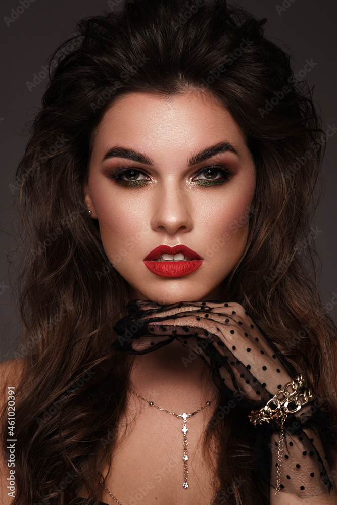 Fototapeta premium Beautiful sexy girl with bright make up, red lips, curl hair. Beauty face.