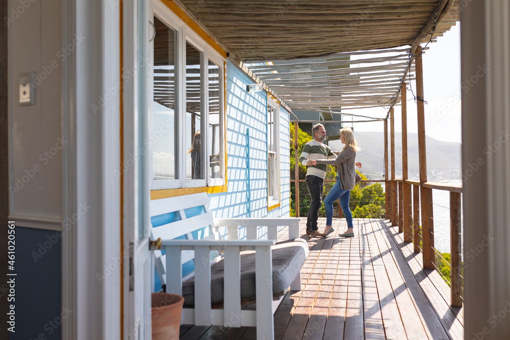 Relaxing caucasian couple dancing on a terrace by the sea Relaxing caucasian couple dancing on a terrace by the sea