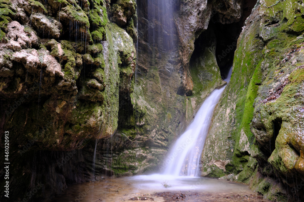 Obraz premium View of Grotto waterfall in Teshebs river gorge on winter day. Gebiusskie waterfalls, Krasnodar Krai, Caucasus, Russia.