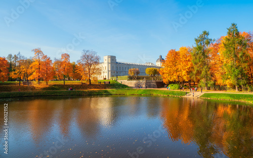 Bright autumn landscape with State Museum Reserve Gatchina. Sunny panoramic autumn view of the park, Karpin Pond and Great Palace in the shore.