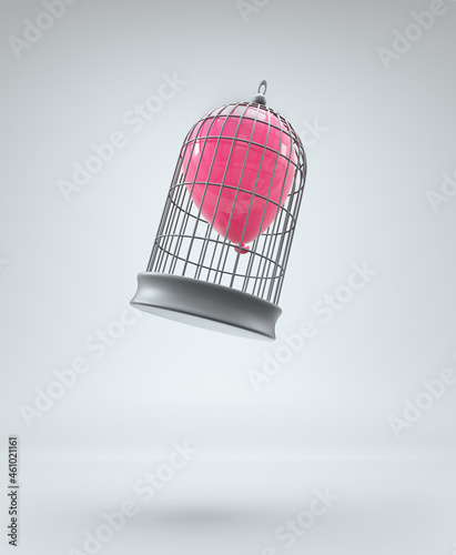 Red balloon inside a bird cage.