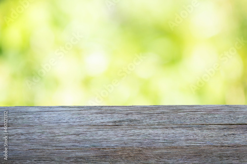 Empty wood table on bokeh nature background.