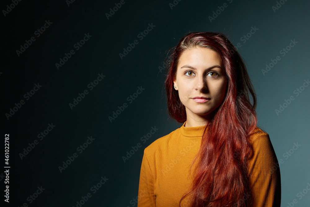 Portrait of beautiful young woman. Beauty portrait of multi-racial girl in orange sweater Portrait of beautiful young woman. Beauty portrait of multi-racial girl in orange sweater