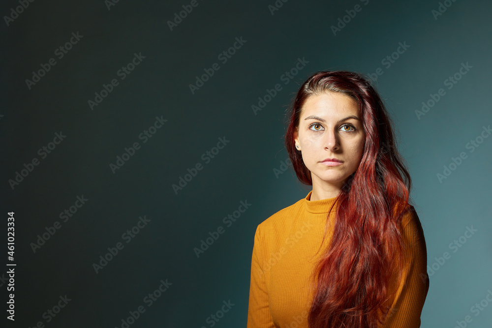 attractive and red-haired young Caucasian woman with orange jersey and great copy space attractive and red-haired young Caucasian woman with orange jersey and great copy space