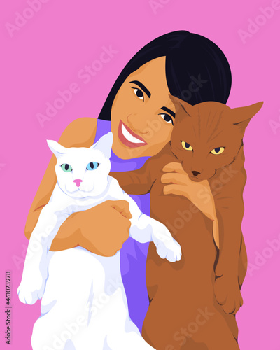 Girl smiling holding two cats