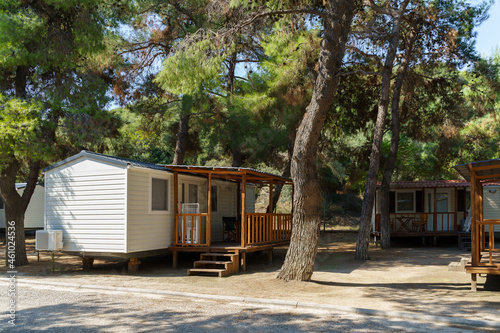 Vacation mobile houses on a campsite with trees around. High quality photo photo