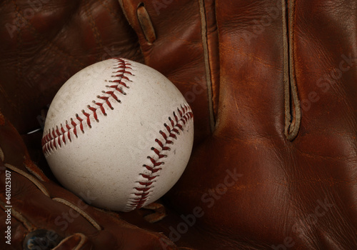 Baseball ball in vintage leather glove