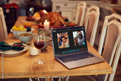 Close-up of African American family greeting during video call over laptop on Christmas.