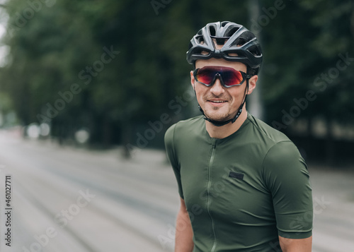 Man in helmet and glasses sitting on bike and smiling © Tymoshchuk