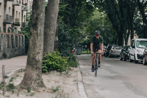 Wallpaper Mural Muscular man in sportswear cycling along city street Torontodigital.ca