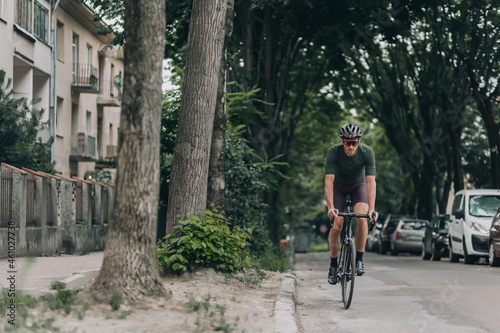 Cyclist riding bike during morning time on street of old © Tymoshchuk