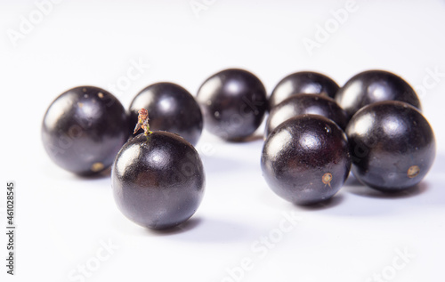 Jabuticaba, Freshly harvested Jabuticabas arranged over white background, selective focus.