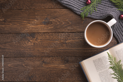 Christmas background with book, cup of coffee and decorations. Holiday decor concept. Overhead, flat lay, top view, copy space