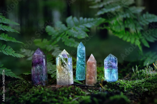 Gemstones minerals on mysterious natural dark forest background. Magic quartz crystals for esoteric Ritual, Witchcraft, spiritual practice. reiki healing therapy for life balance. photo