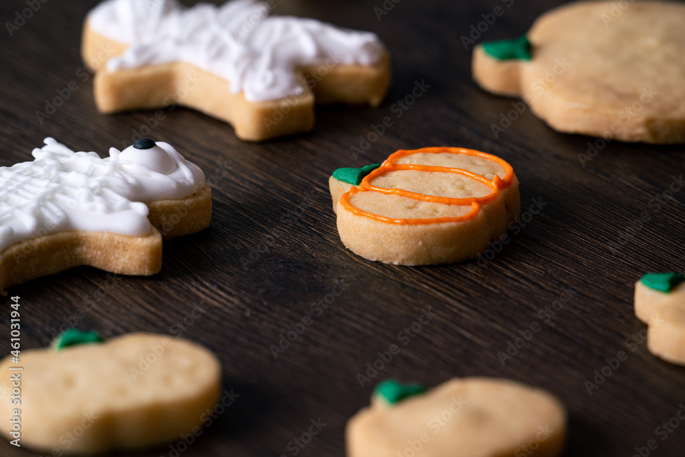 Decorating cute Halloween pumpkin cookies with frosting in icing bag. Decorating cute Halloween pumpkin cookies with frosting in icing bag.