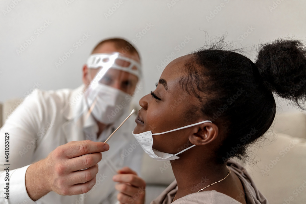 African Woman Having A Nasal Swab Test Done By Pediatrician Shot Of african-woman-having-a-nasal-swab-test-done-by-pediatrician-shot-of