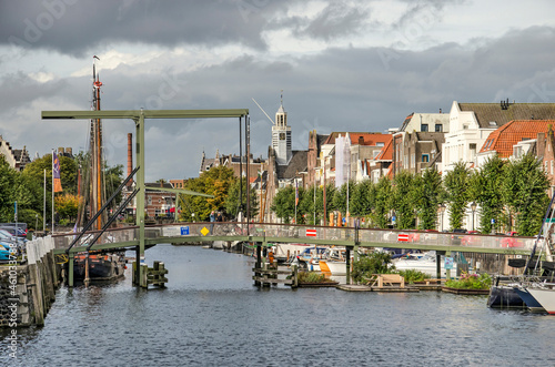 Rotterdam, The Netherlands, October 3, 2021: view along scenic Voorhaven canal in Delfshaven neighbourhood, with boats and traditional houses photo