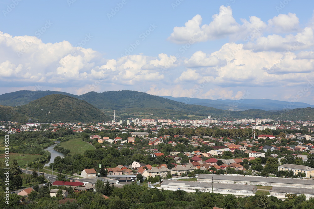 Scenic view of the town in the mountains on a cloudy summer day.