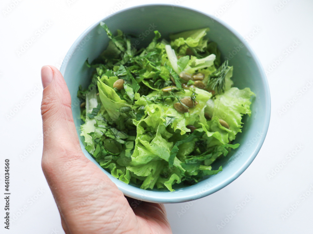 fresh salad leaves with pumpkin seeds in a plate, close-up. Comfortable digestion, proper nutrition, weight loss. The texture of vegetables, salad. Seasonal vitamins, fiber fresh salad leaves with pumpkin seeds in a plate, close-up. Comfortable digestion, proper nutrition, weight loss. The texture of vegetables, salad. Seasonal vitamins, fiber