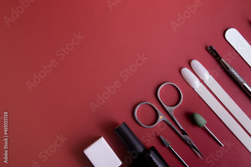 Manicure tools and tips on a colored background with copy space