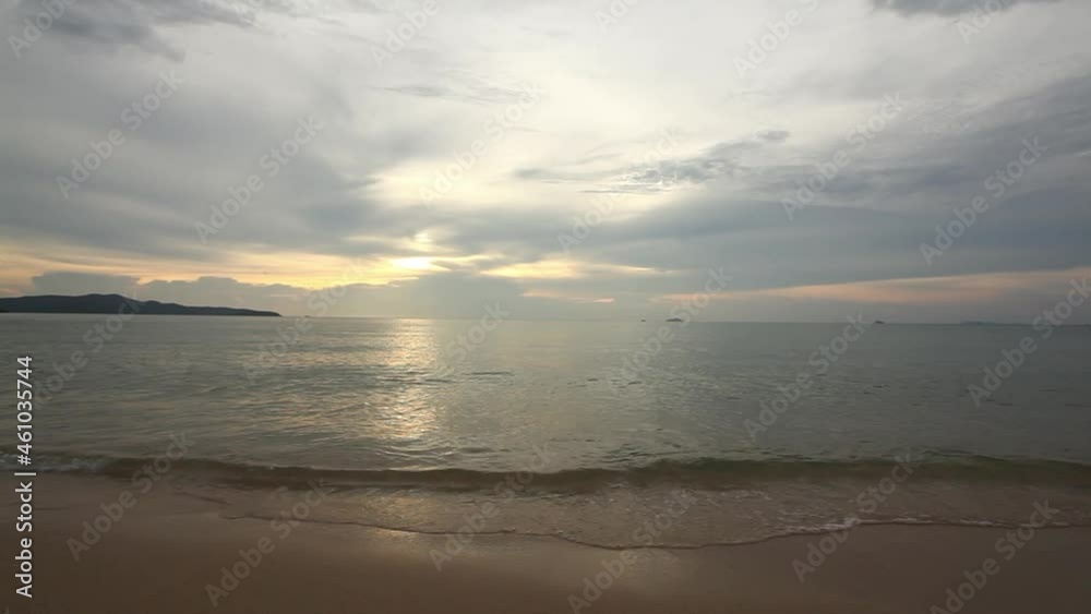 Beautiful tropical sea with waves crashing into the sand. sunset light Beautiful tropical sea with waves crashing into the sand. sunset light