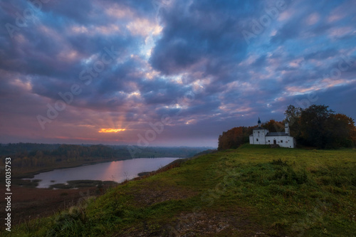 Church of St. Nicholas the Wonderworker in Malskaya valley at dawn Izborsk city, Pskov region in Russia, overlooking the Gorodischenskoye lake photo