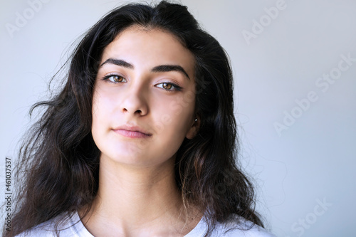 Tableau sur toile young woman with a serious look on her face - gray background with copy space