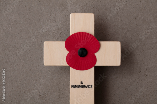 A red remembrance poppy on a wooden cross. Military remembrance day concept photo