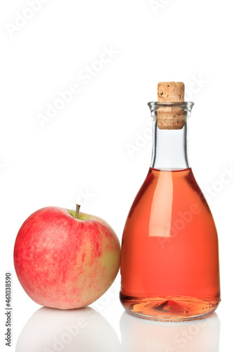 Bottle of apple cider and red apple isolated on white background.