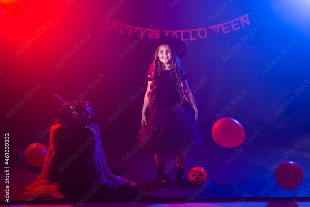 Funny child girl in witch costume for Halloween with pumpkin Jack. Funny child girl in witch costume for Halloween with pumpkin Jack.