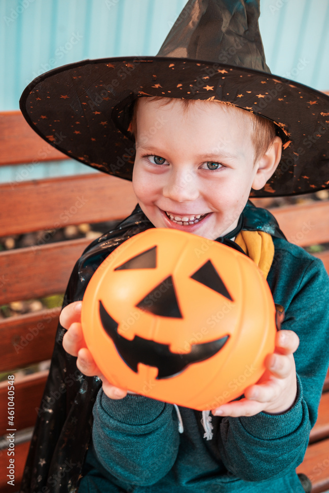 Halloween kids. Cute little boy, child wearing witch hat with orange candy bucket Jack O Lantern. Happy Halloween. Halloween kids. Cute little boy, child wearing witch hat with orange candy bucket Jack O Lantern. Happy Halloween.