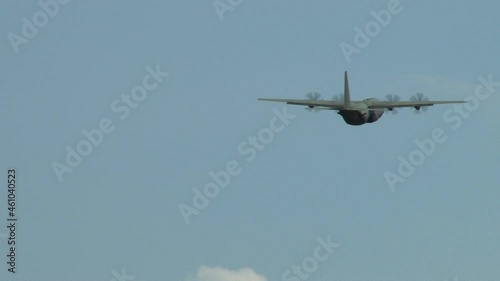 Lockheed C-130 Hercules аmerican military-transport four-engine turboprop aircraft gaining height after take-off. Close-up of airplane and rotating propellers. Zhukovsky, Russia, August 10, 2012
