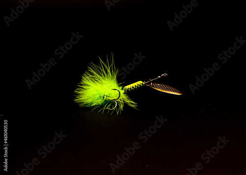 Spinner Lure with three hooks spinnerbaits pulsating hackle tail isolated on black photo