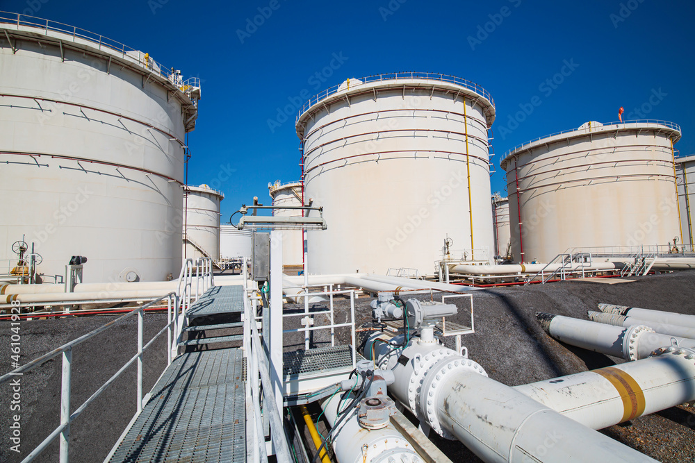 Row of large white tanks for petrol pipeline oil Row of large white tanks for petrol pipeline oil