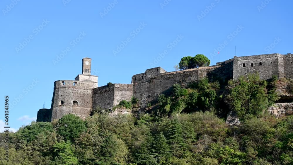 Aerial drone view of old fortress and clock tower in Gjirokastër, Albania. UNESCO World Heritage Site. Historical buildings, architecture and cultural heritage. Castle of Gjirokaster, view from above. Aerial drone view of old fortress and clock tower in Gjirokastër, Albania. UNESCO World Heritage Site. Historical buildings, architecture and cultural heritage. Castle of Gjirokaster, view from above.