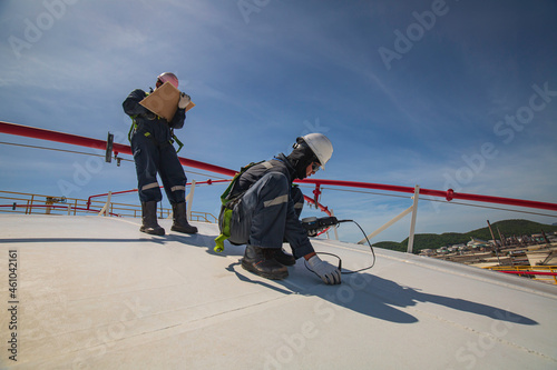 Male two worker are for inspection ultrasonic thickness roof plate dome top tank