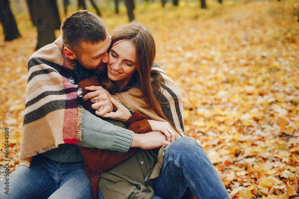 Fototapeta premium Beautiful couple spend time in a autumn park