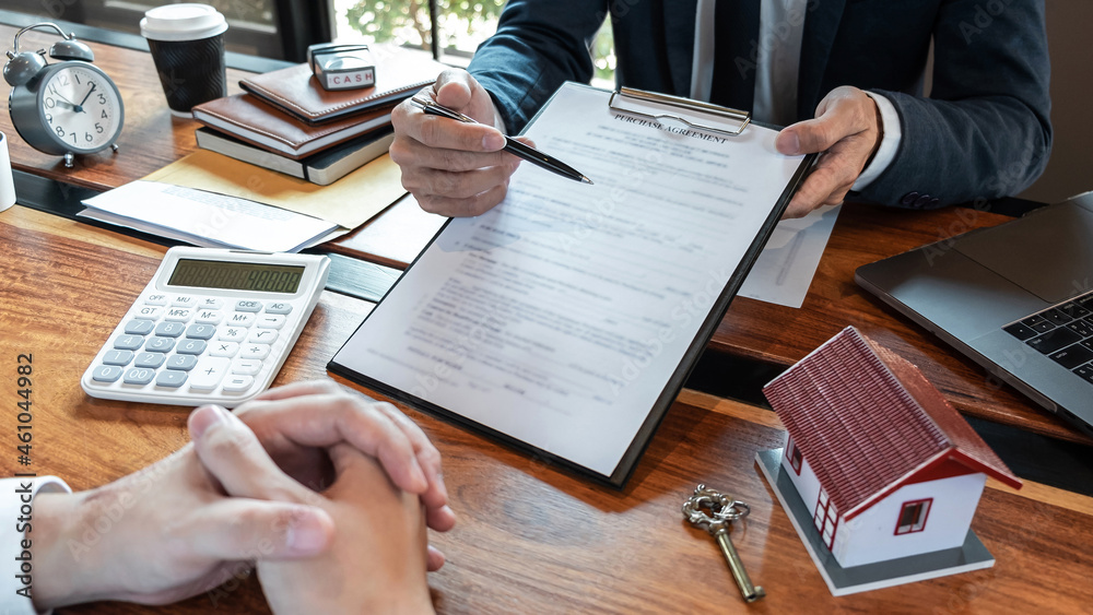 Real estate agent are presenting home loan and sending keys to customer after signing contract to buy house with approved property application form, Insurance Home concept
