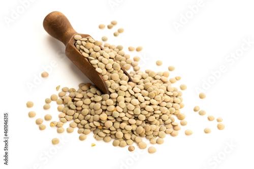 Lentil on wooden scoop isolated on white background. Lens culinaris