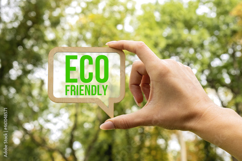 A woman holds a sign inside which the inscription - Eco Friendly. Ecology concept. Eco friendly and corporate social responsibility campaign concept.