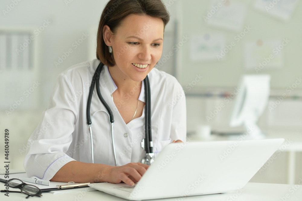 doctor sitting at desk at work in hospital doctor sitting at desk at work in hospital