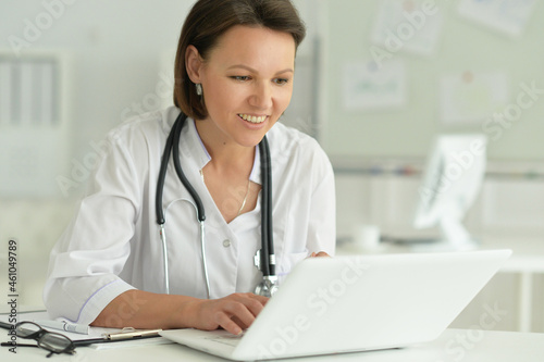 doctor sitting at desk at work in hospital