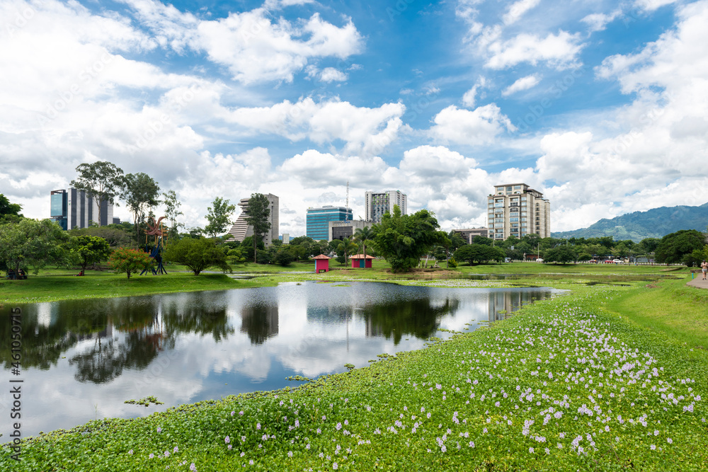 San jose, Costa Rica. August 8, 2021: Beautiful landscape in La Sabana park with reflection of blue sky in the water. 