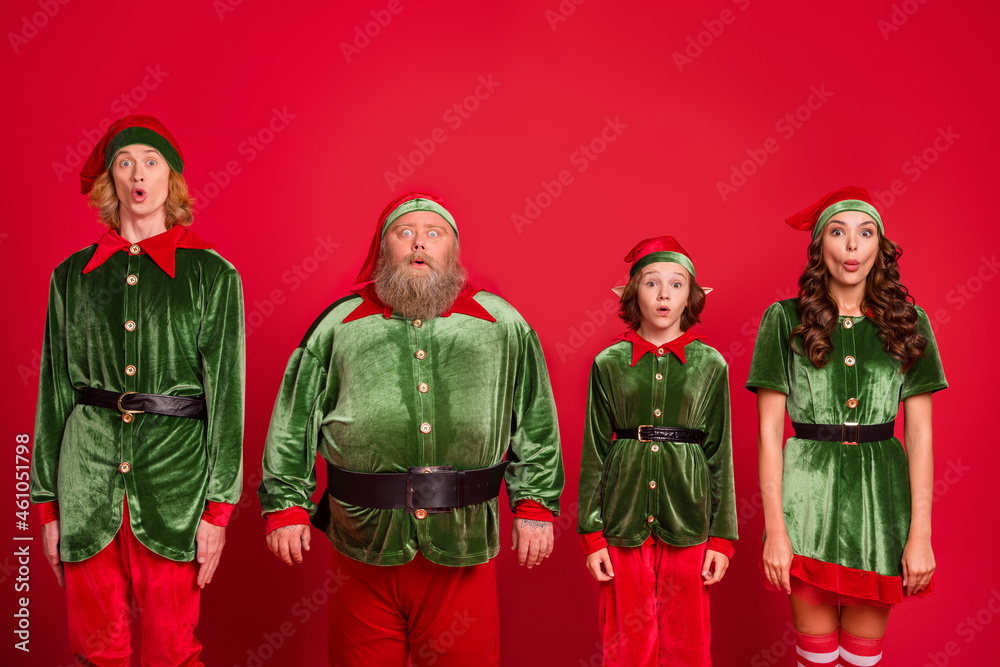 Photo of sad santa team people different heigh stand wear new year cloth isolated on red color background